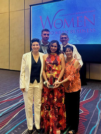 Jessica Kuhn poses with her award with four of her family members.