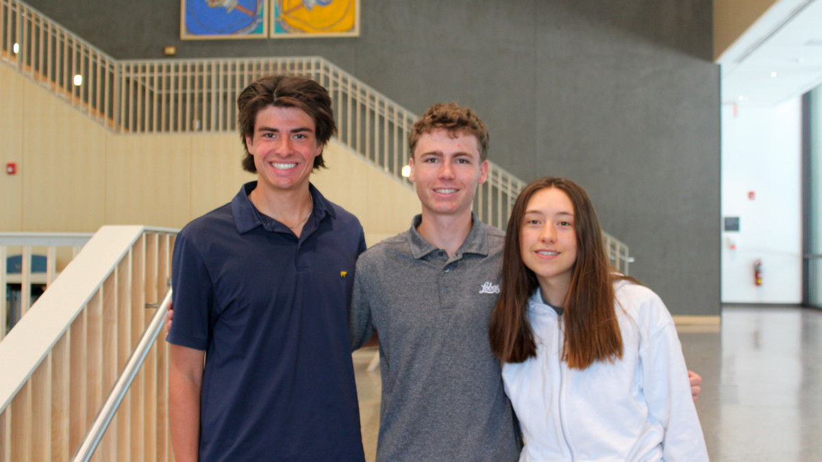 Students Gavin Richards Nicco Huggins and Antonella Abriola pose in McKinnon Center lobby