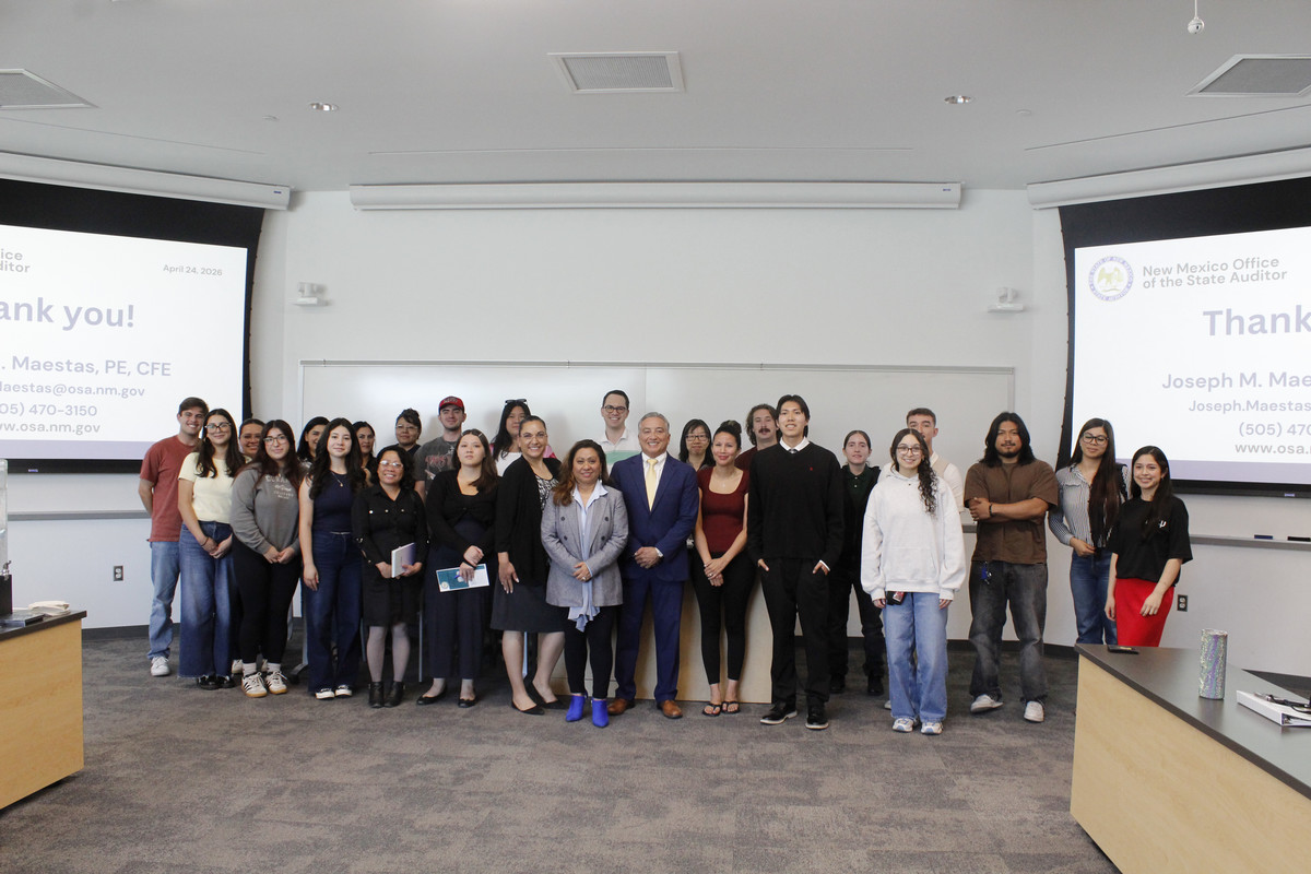 Student attendees and the Office of the State Auditor personnel pose in a group photo in a McKinnon Center classroom.