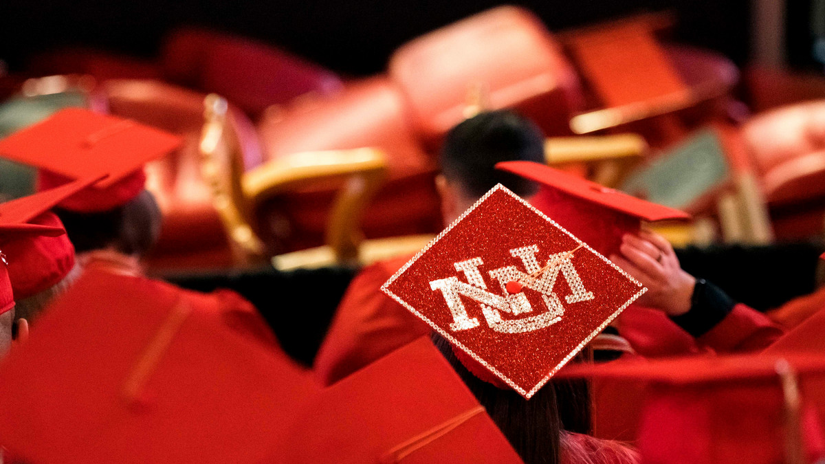 Decorative image of students in graduation regalia with a graduate cap decorated with UNM logo in gems.