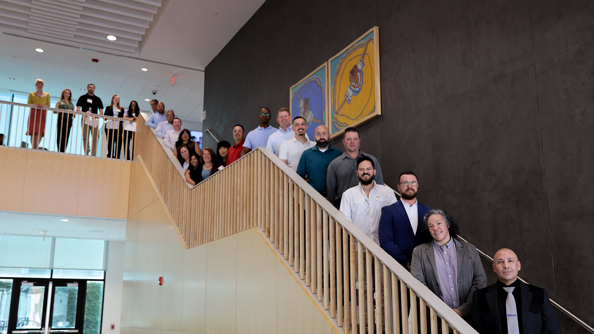 Image of EMBA Class of 2028 along the stairs in the McKinnon Center